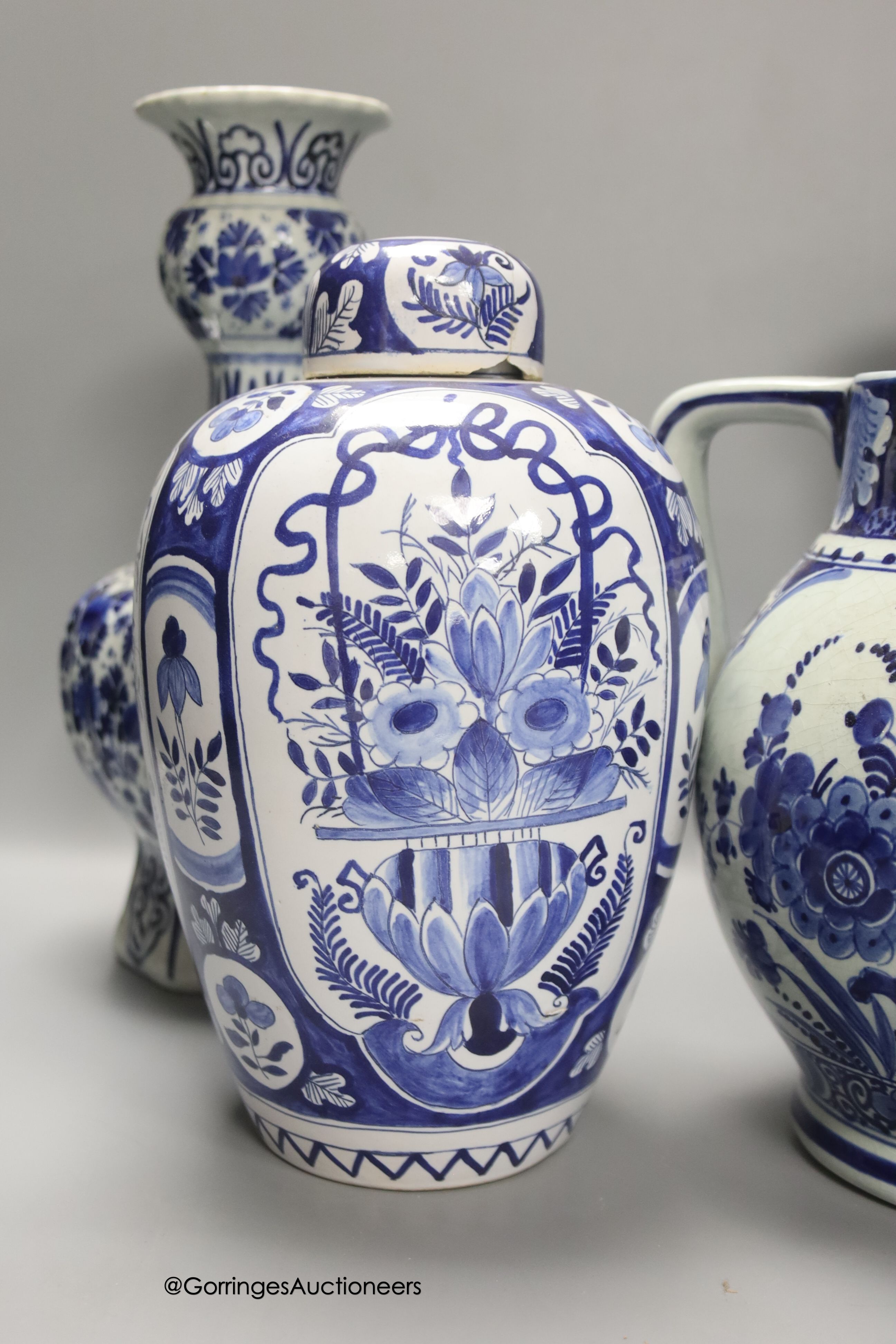 A pair of Dutch Delft blue and white vases, 29cm, a similar ovoid jar and cover and a bulbous jug